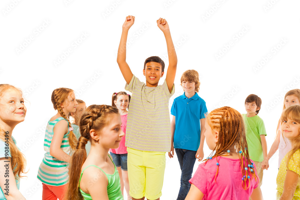 Boy stand in the crowd with lifted hands