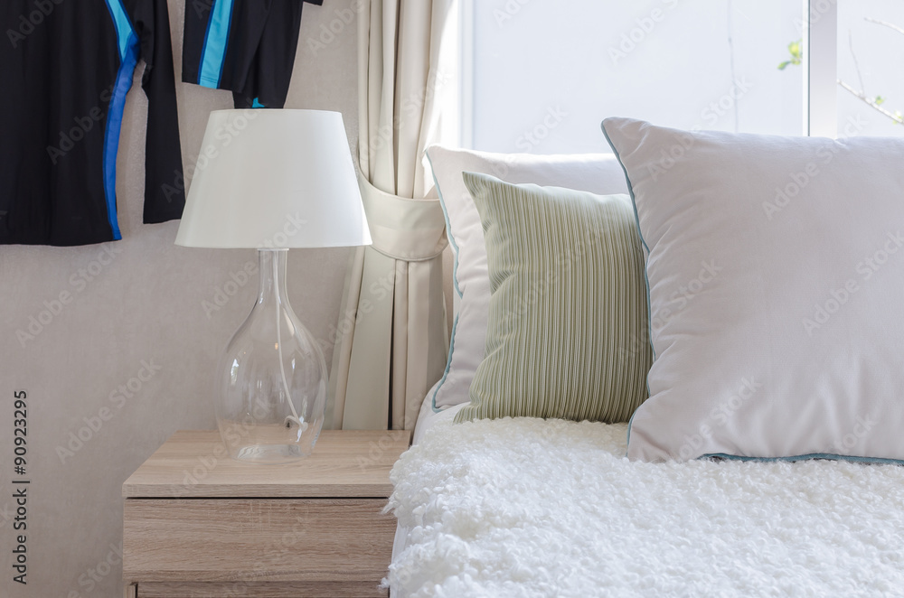 modern glass lamp on wooden side table in bedroom