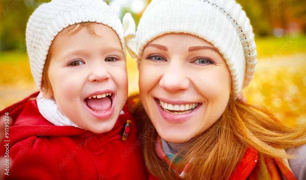 happy family on autumn walk is photographed doing SELF