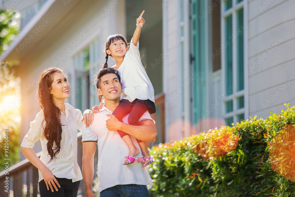 Beautiful family portrait smiling outside their new house