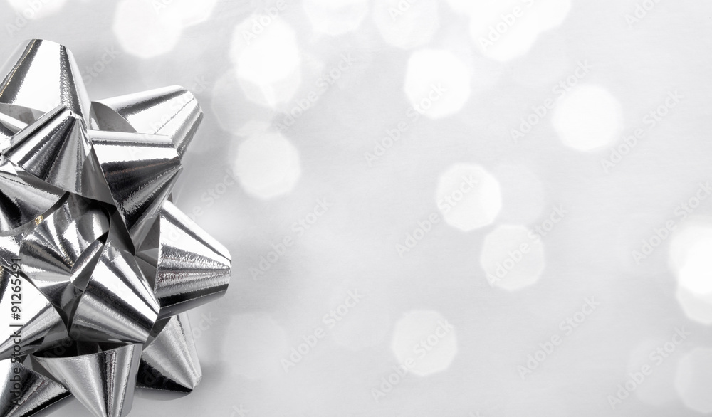 Closeup of silver bow on abstract background