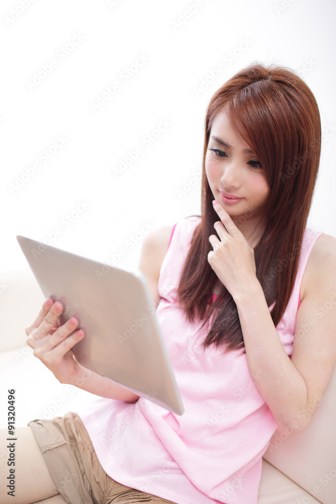 happy woman using tablet pc on sofa