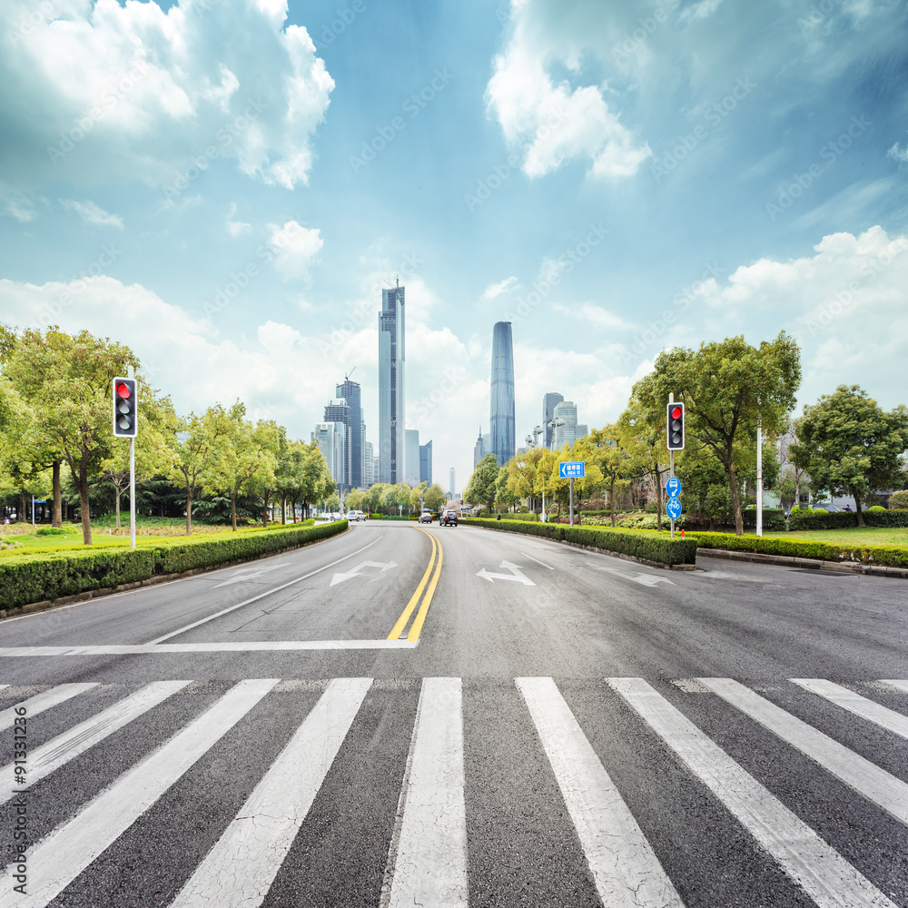 empty road with zebra crossing and skyscrapers