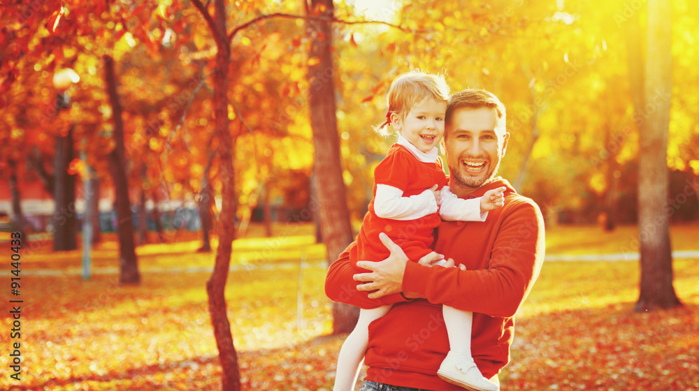 Happy family father and child daughter on a walk in autumn leaf