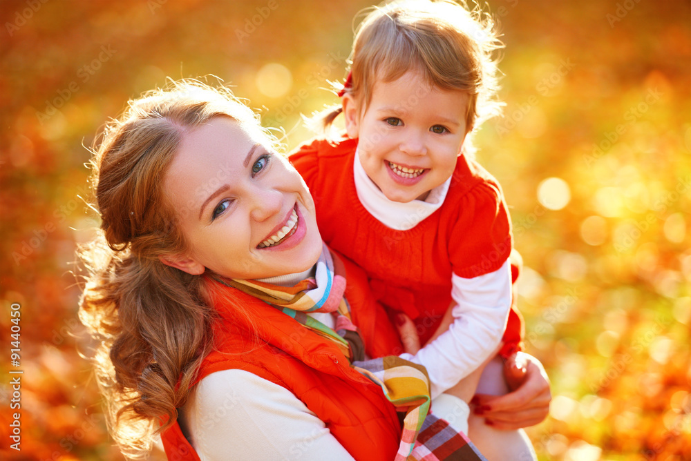 happy family: mother and child little daughter play cuddling on