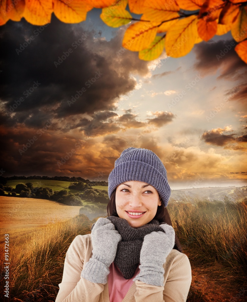 Composite image of smiling brunette wearing warm clothes