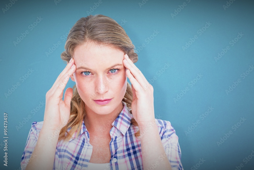 Composite image of pretty hipster with headache 