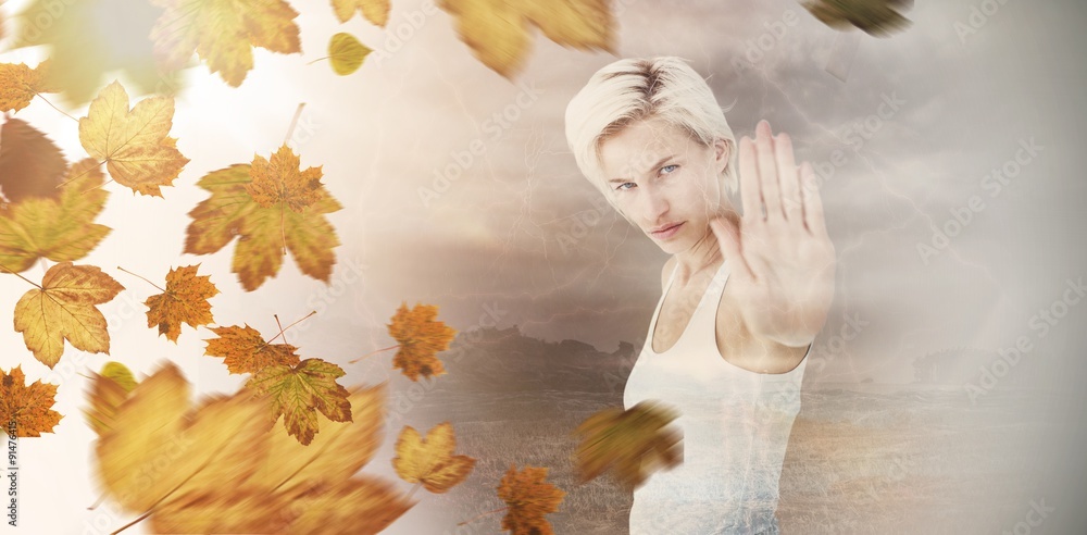 Composite image of angry pretty blonde showing her hand 