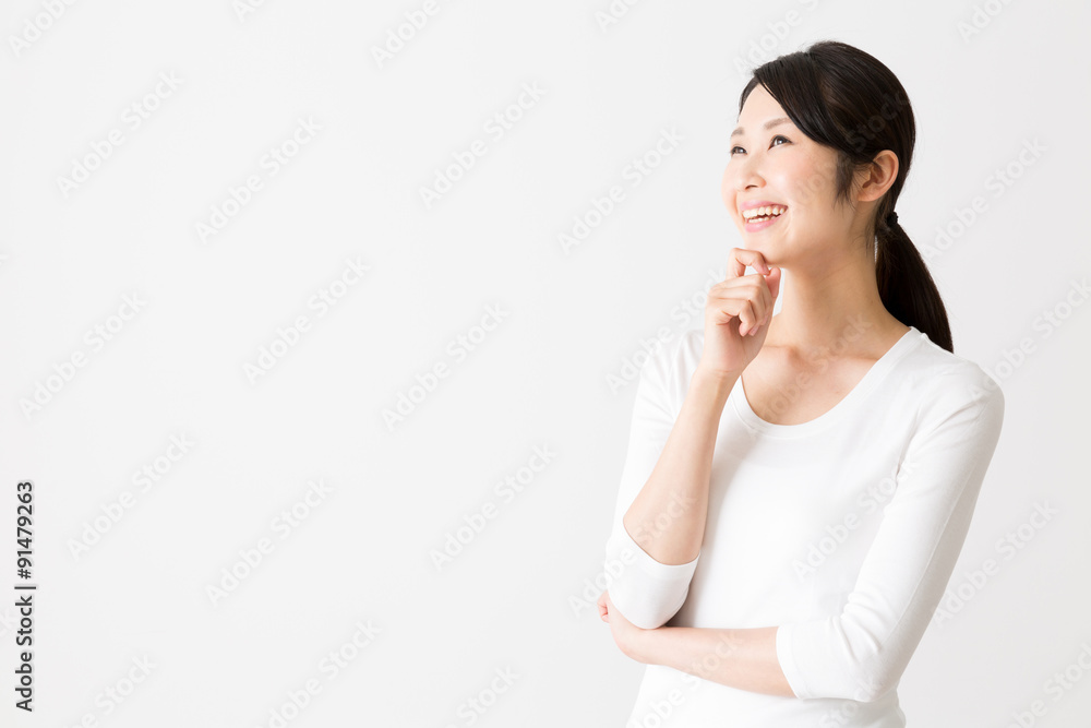 portrait of attractive asian woman thinking on white background