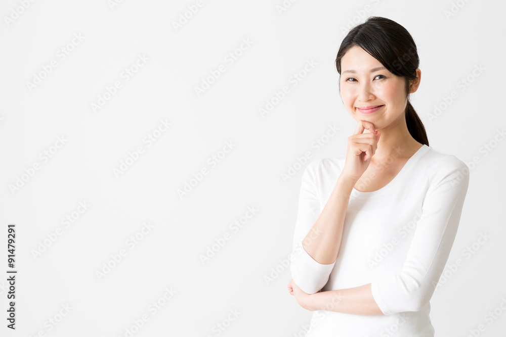 portrait of attractive asian woman thinking on white background