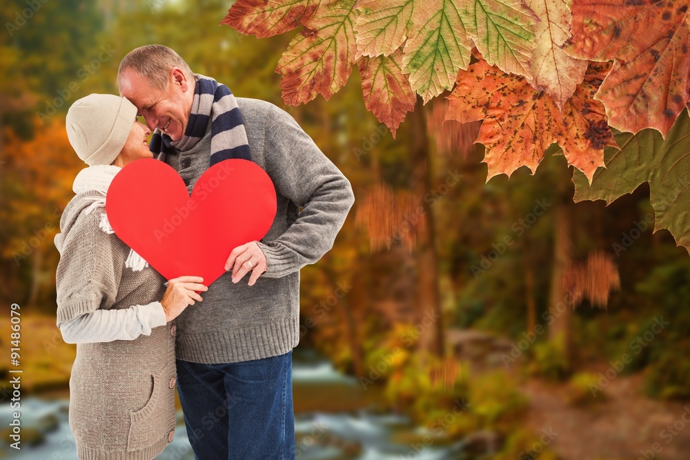 Composite image of happy mature couple in winter clothes