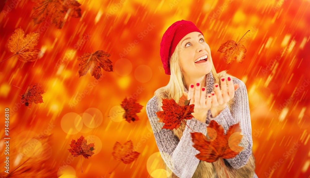 Composite image of blonde in winter clothes with hands out