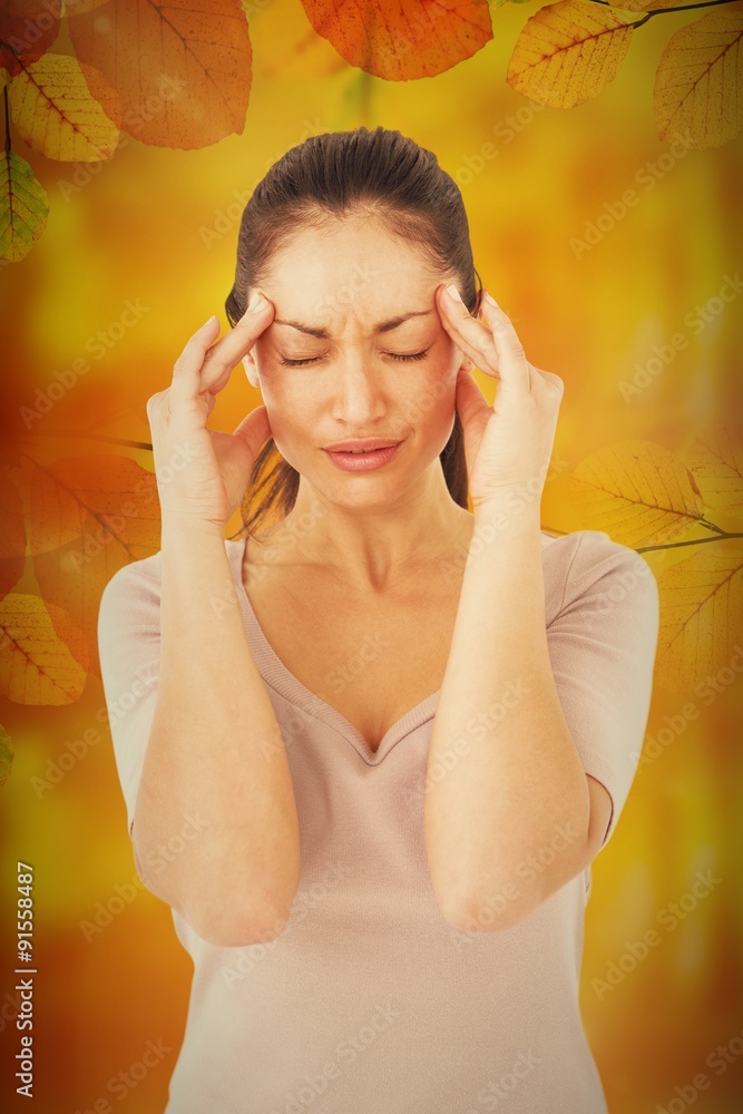 Composite image of brunette suffering from migraine 