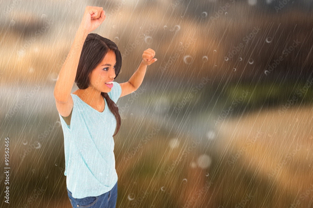 Composite image of brunette cheering