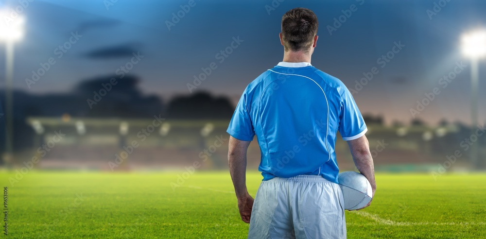 Composite image of rugby player holding a rugby ball