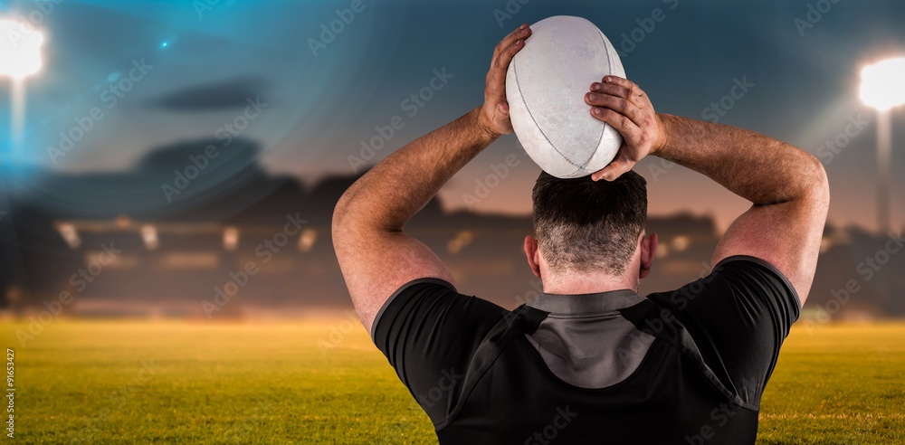 Composite image of tough rugby player throwing ball