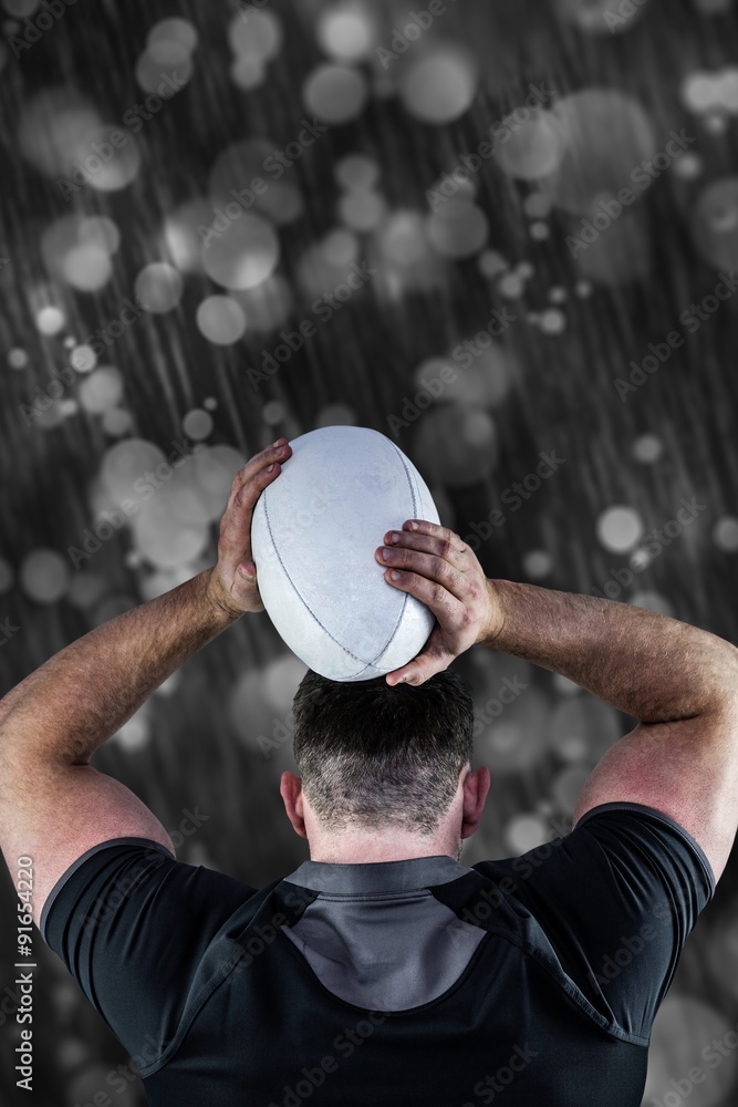 Composite image of tough rugby player throwing ball