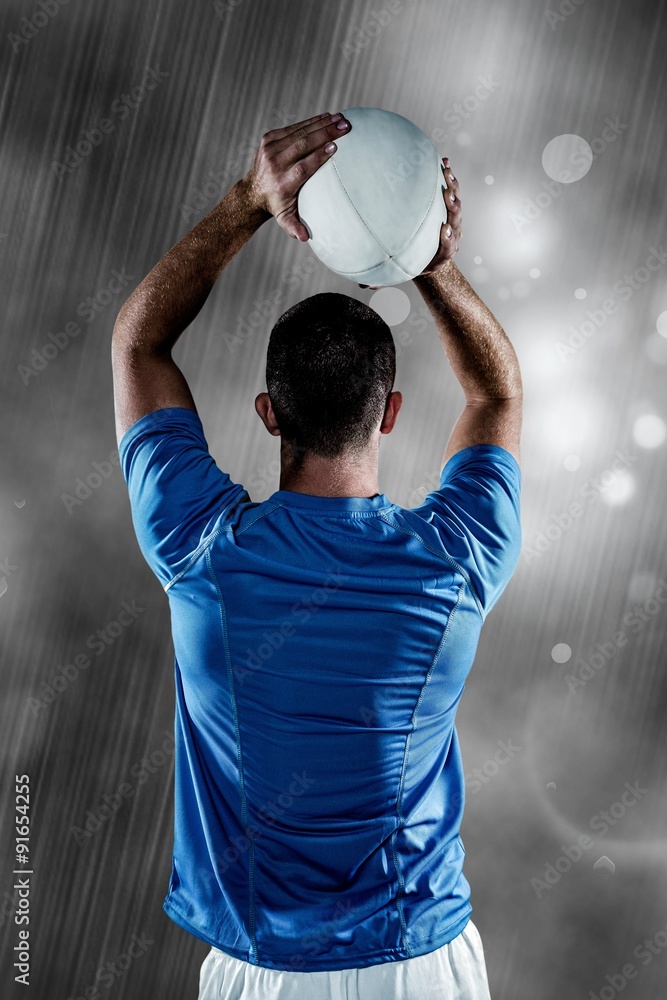 Rear view of rugby player throwing ball