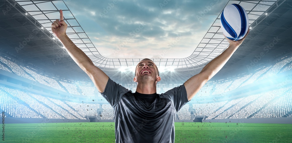 Composite image of successful rugby player holding ball