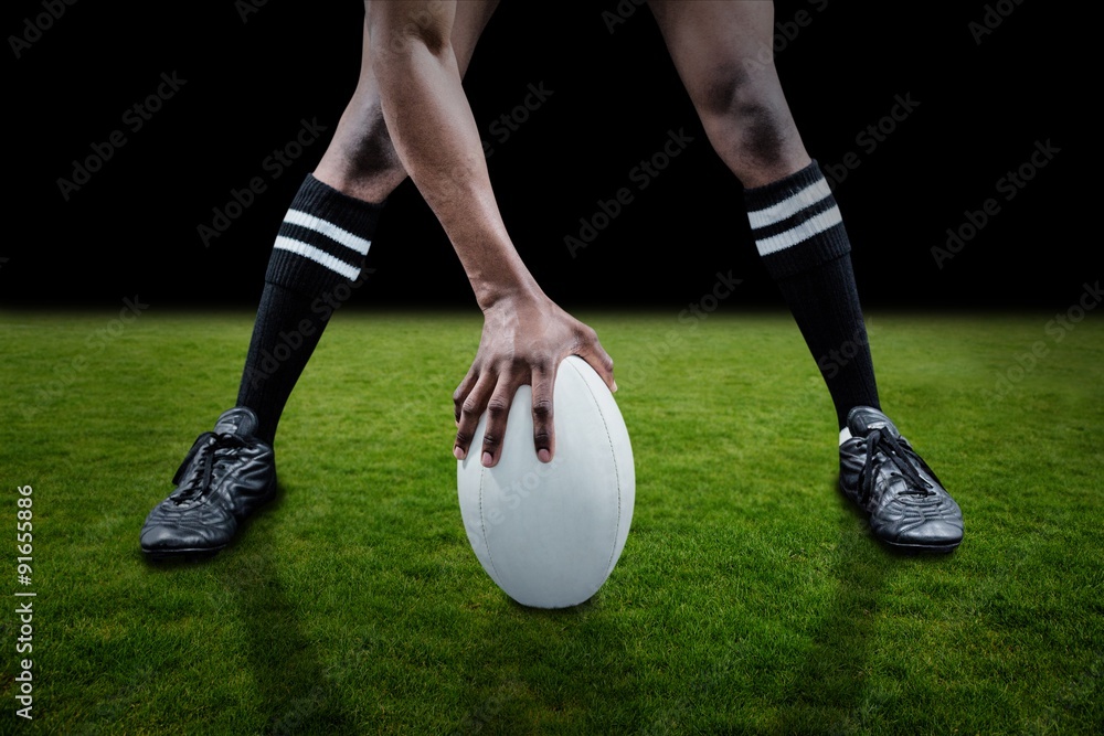 Composite image of low section of sportsman playing rugby