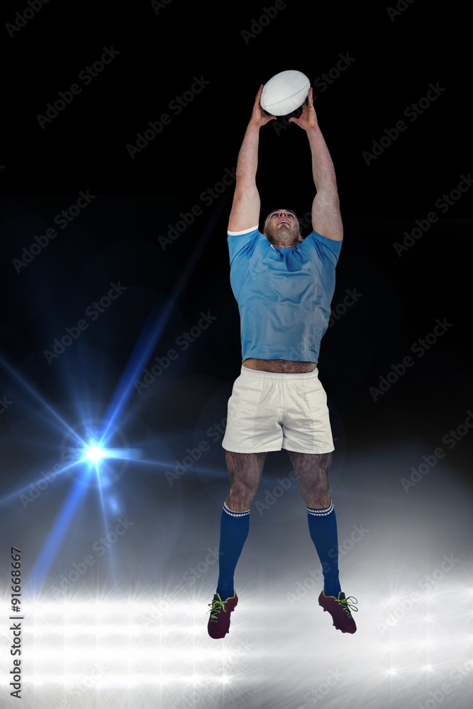 Composite image of rugby player catching the ball