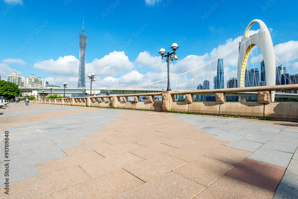 modern square and skyscrapers under blue sky