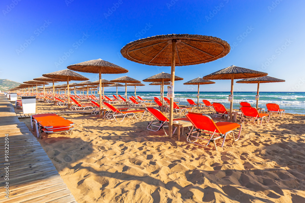 Parasols and deckhcairs on the Banana Beach of Zakynthos island, Greece