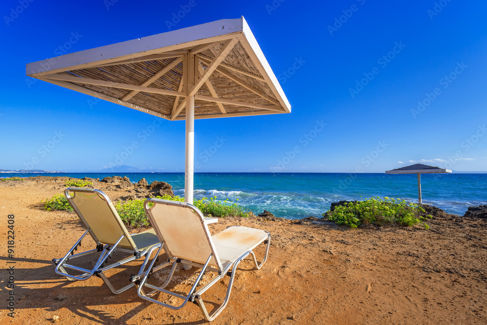 Parasol and deckhcair on the Banana Beach of Zakynthos island, Greece