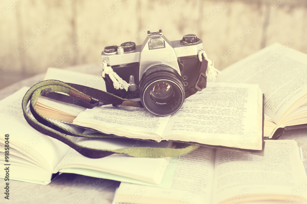 Old photo camera and books, vintage photo effect