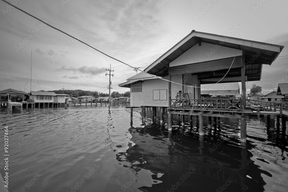 Black and white house on river