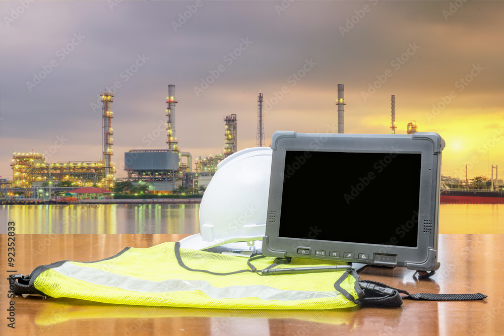 Rugged computers tablet in front of oil refinery industry