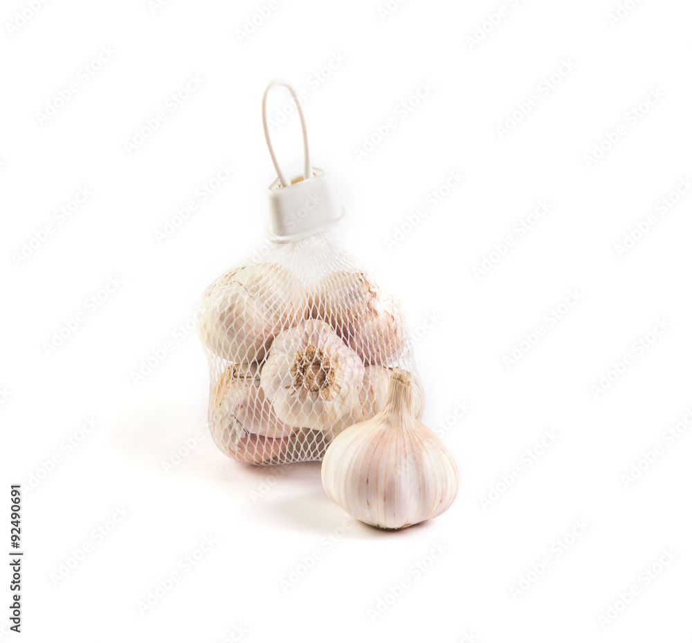 garlic in net bag for sale in market on white background