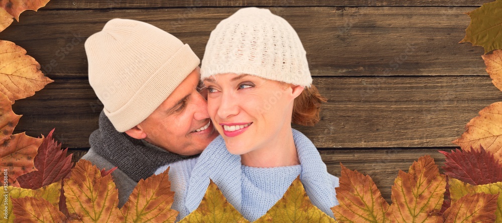 Composite image of casual couple in warm clothing