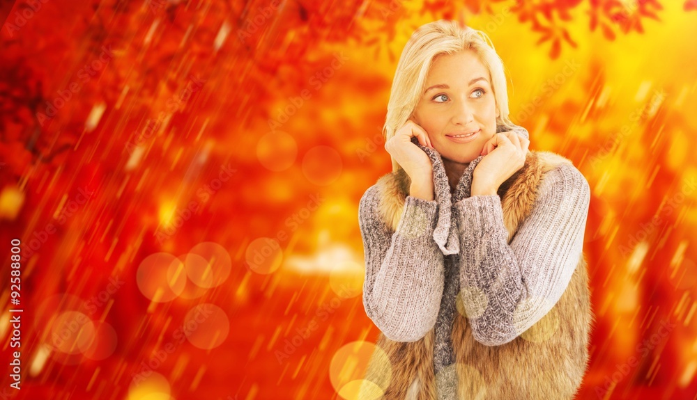 Composite image of blonde in winter clothes smiling 