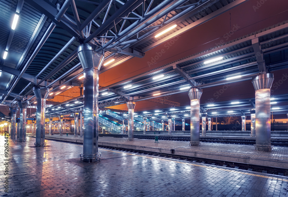 Railway station at night. Train platform in fog. Railroad