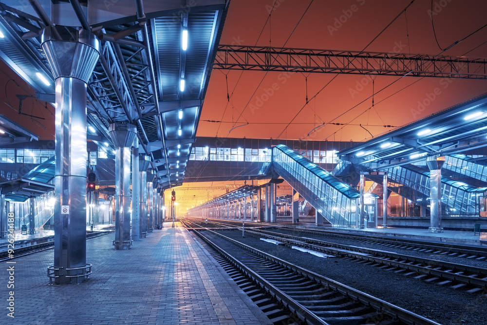 Railway station at night. Train platform in fog. Railroad