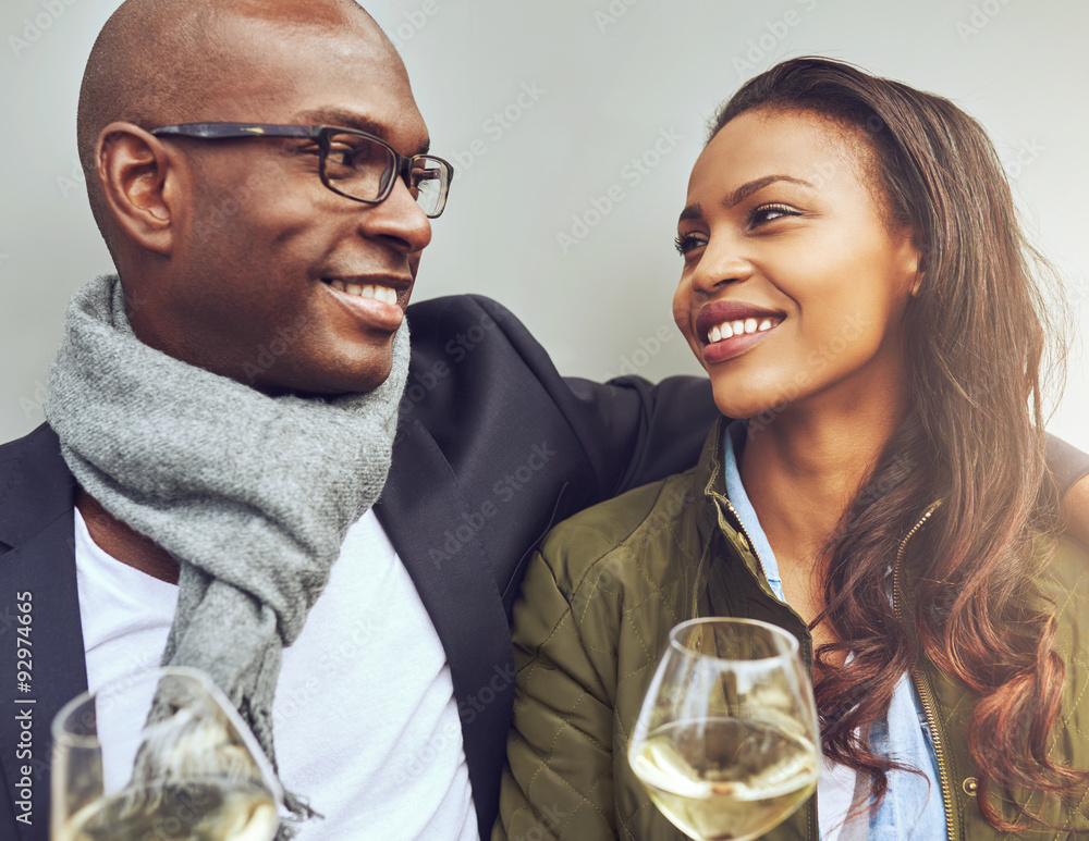 Romantic young African couple enjoying wine