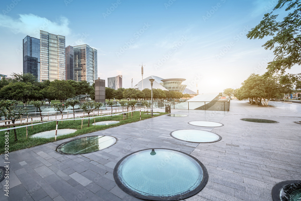 modern square and skyscrapers under sunbeam