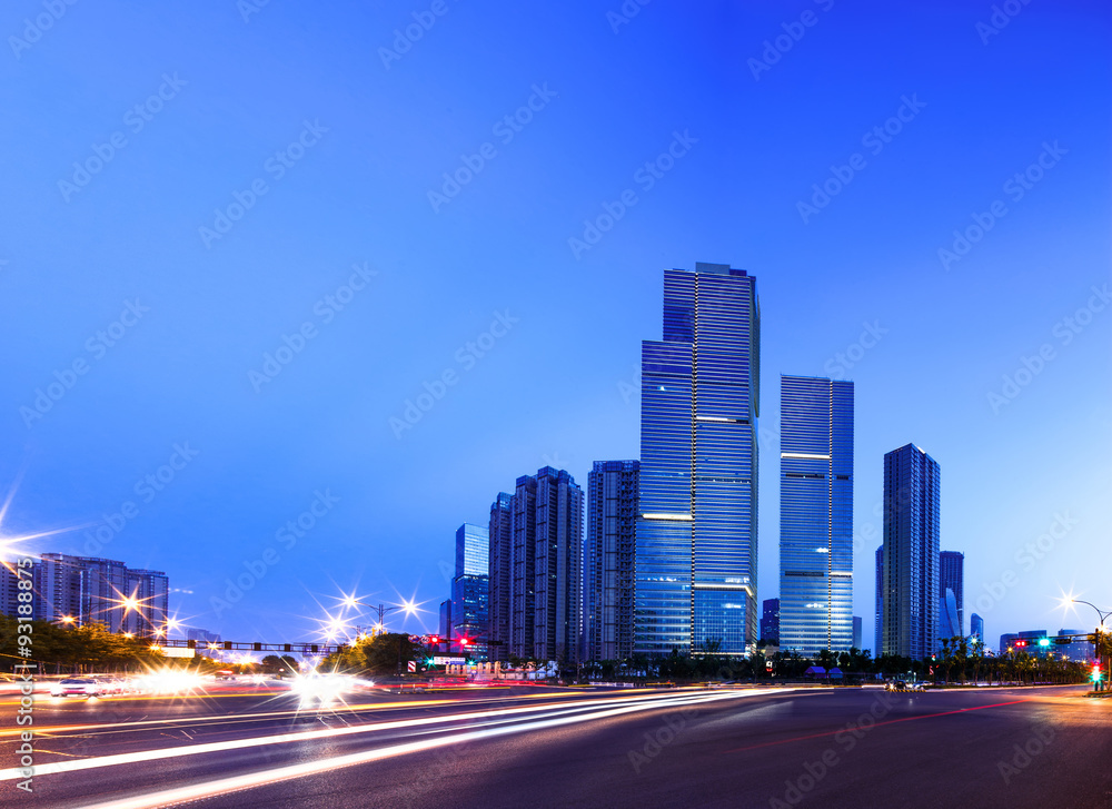 asphalt road near skyscrapers at night