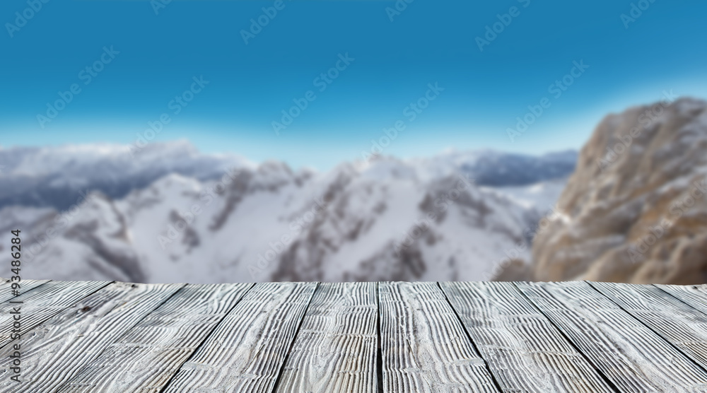 Winter snowy landscape with wooden planks