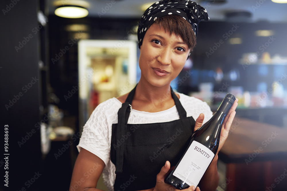 African American lady presenting a bottle of wine