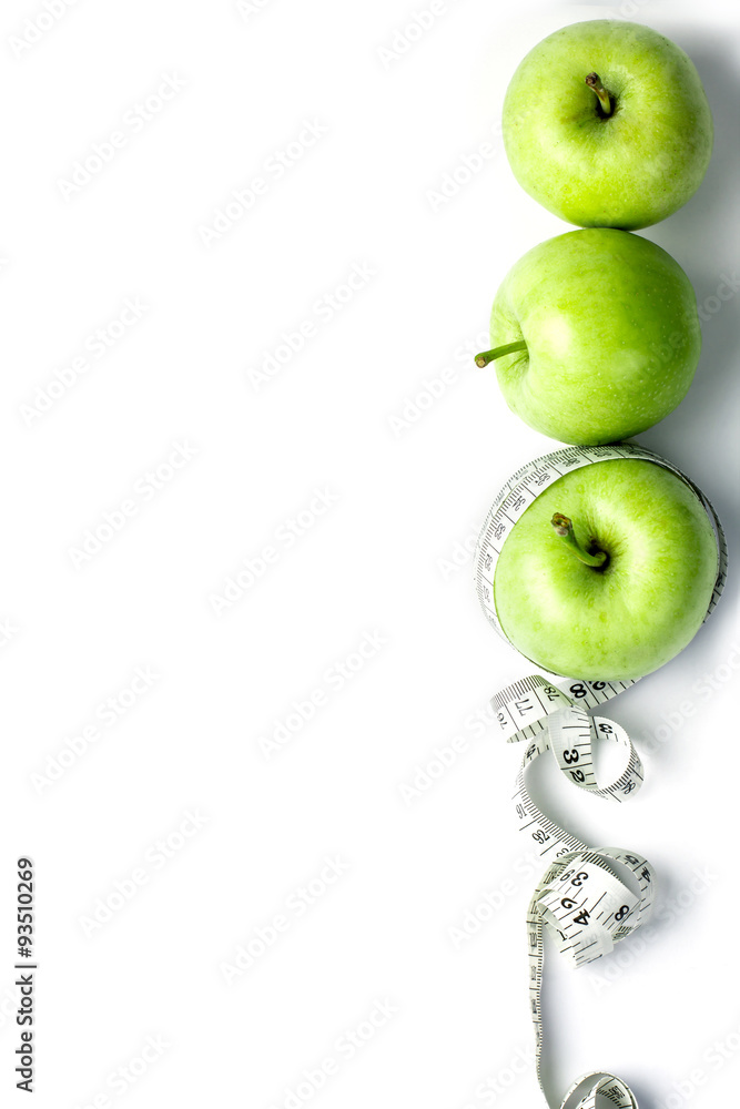 green apple with Measuring tape in diet concept 