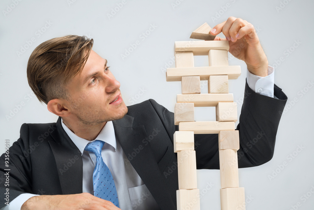 Businessman making tower