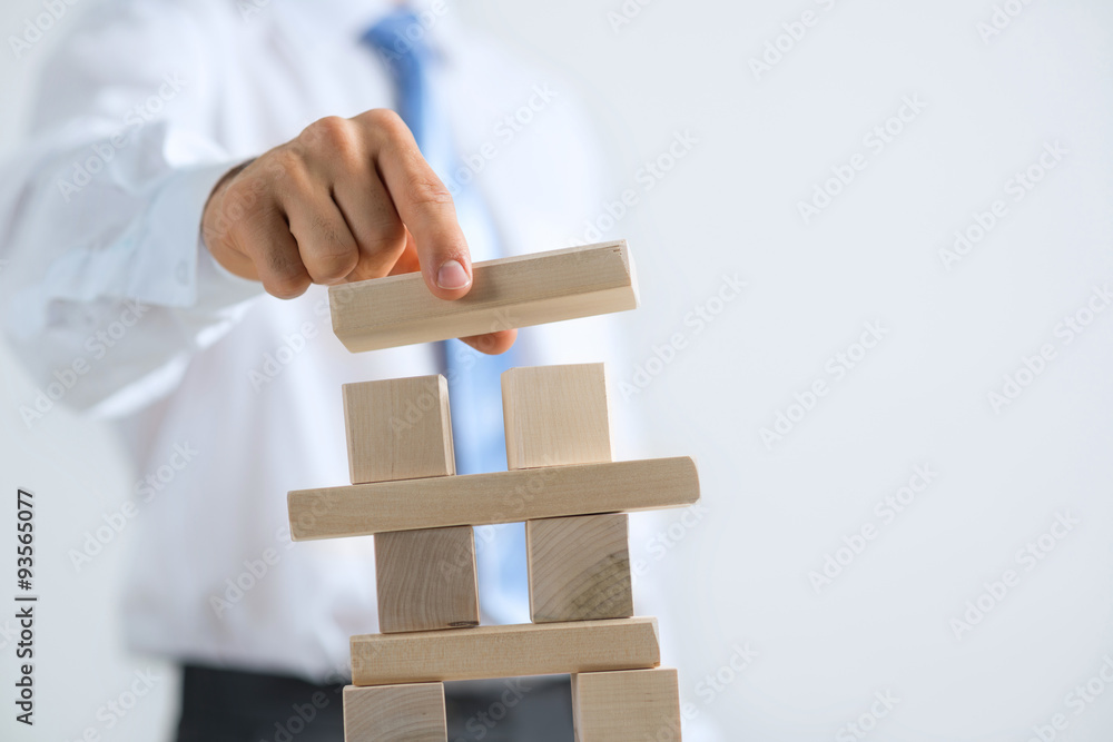 Businessman making tower