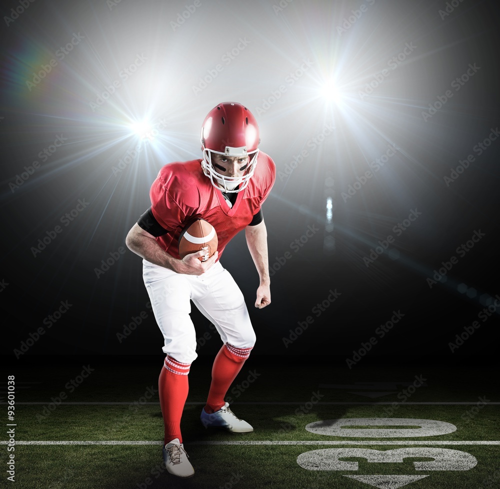 American football player holding ball