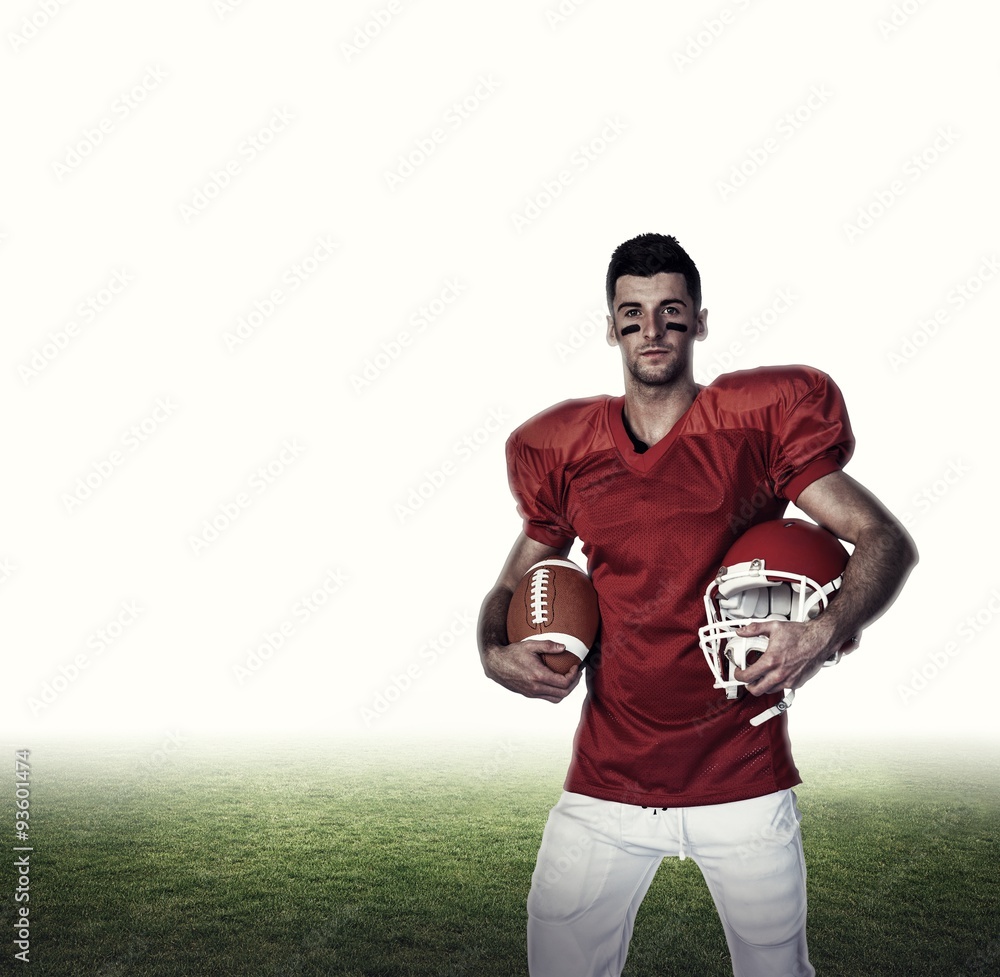 Player holding rugby ball and helmet