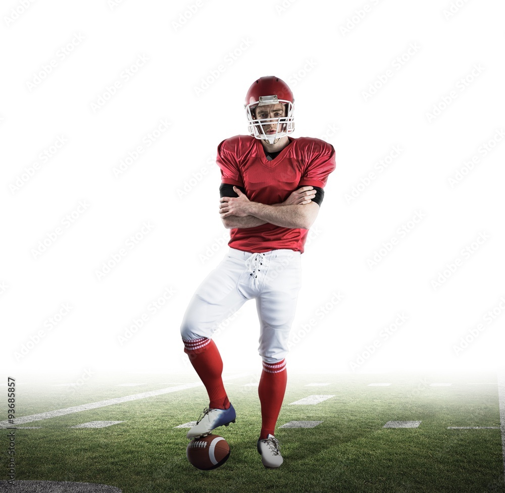 Composite image of american football player with arms crossed