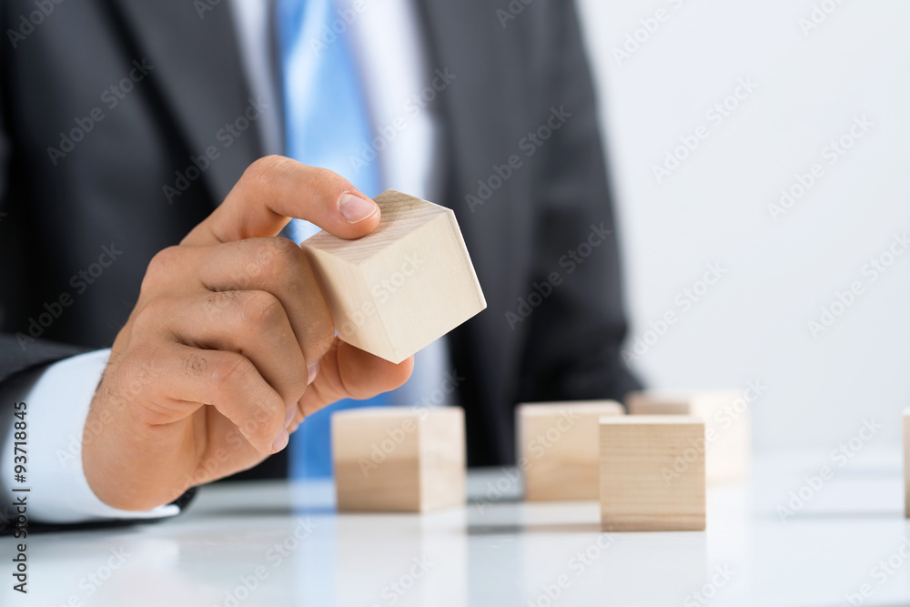 Businessman making tower