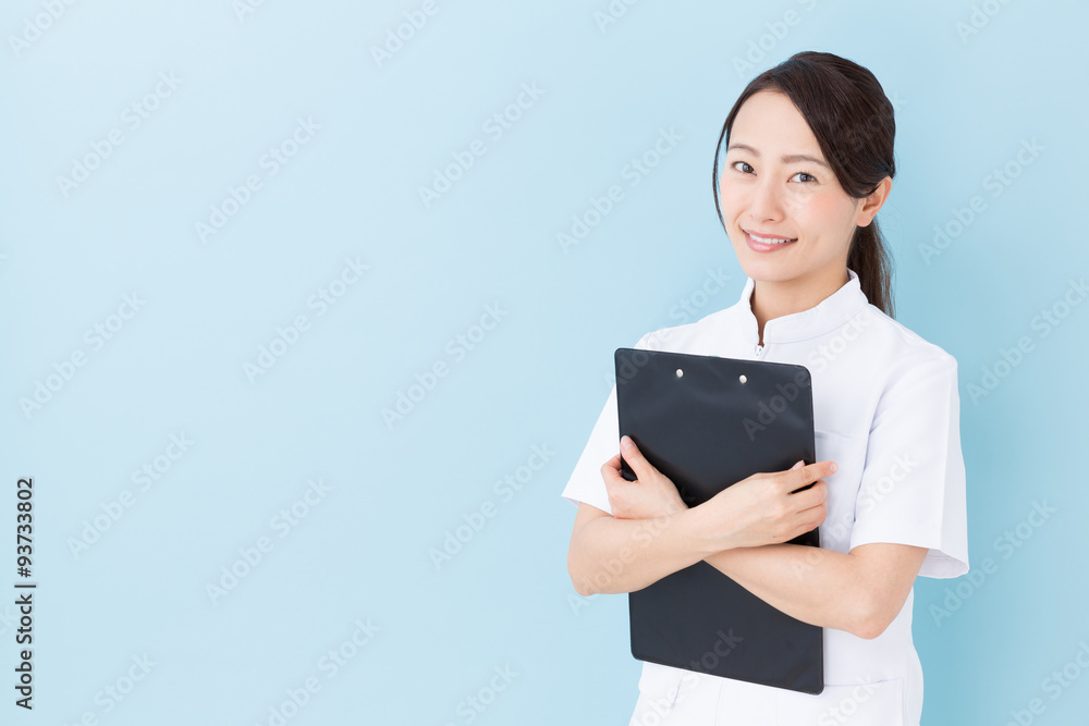 portrait of asian nurse on blue background