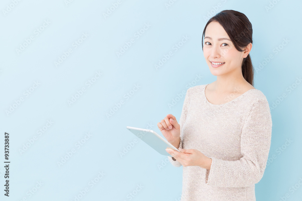 young asian woman using tablet computer